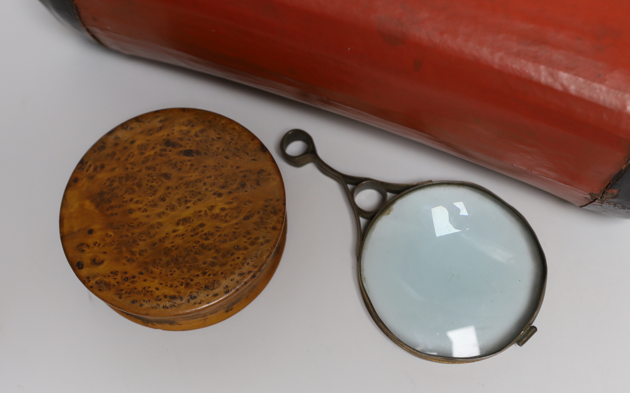A 19th century burr walnut snuff box, a gilt brass magnifying glass and a Chinese pillow, the largest 31cm wide